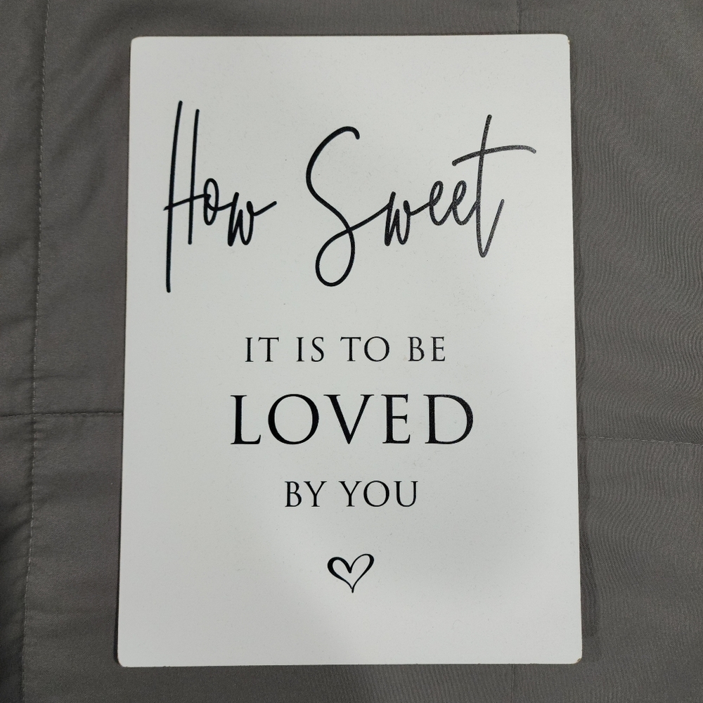 White Decorative Sign with Black Text